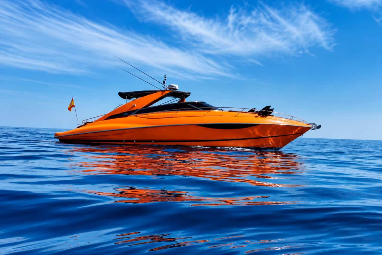 Orange Sunseeker motor yacht on calm blue water during a private charter in Lanzarote.