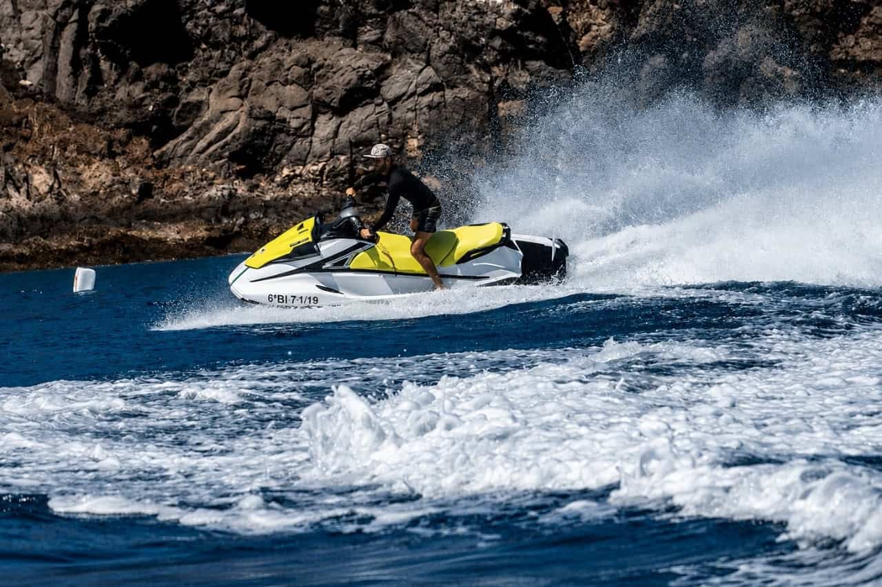 Rider speeding along the rocky volcanic coast of Lanzarote