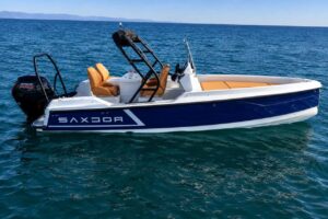 Blue and white Saxdor motorboat floating on the ocean in Lanzarote.