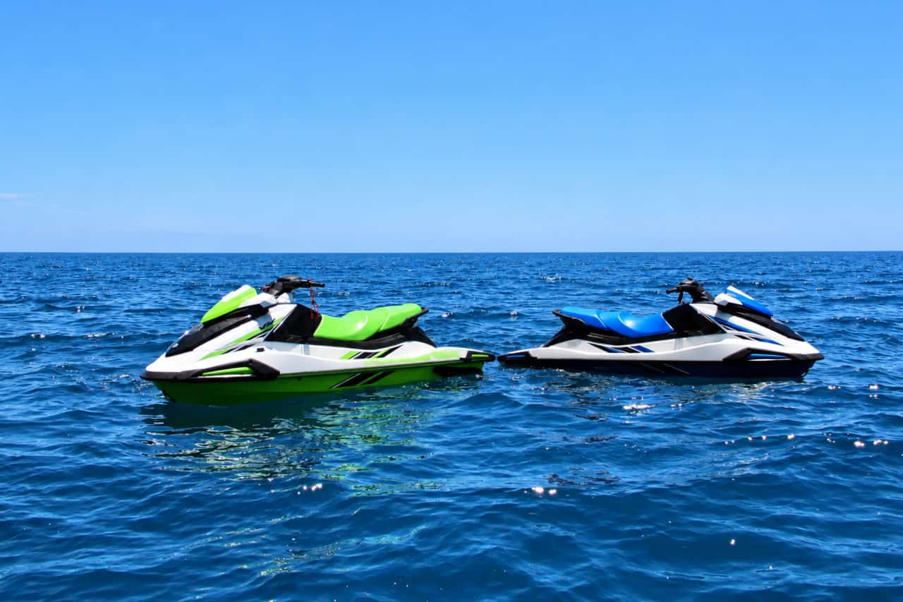 Two Yamaha jet skis floating on the open water