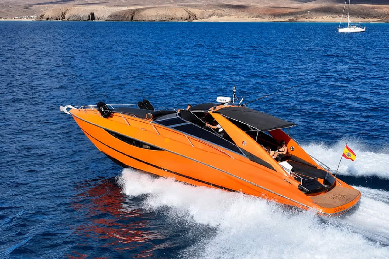 Orange Sunseeker travelling at high speed during a luxury boat trip in Lanzarote.