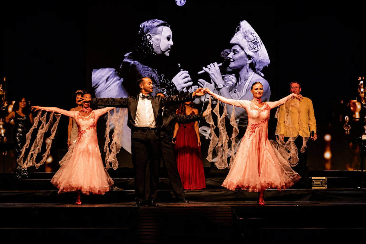 Costumed performers on stage during the History Evolution of Music show in Tenerife