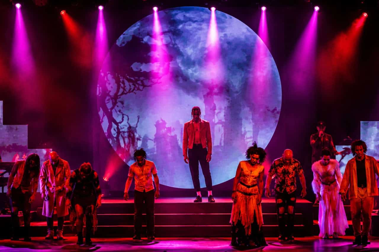 Live dancers performing under pink and purple lights during the History show in Tenerife