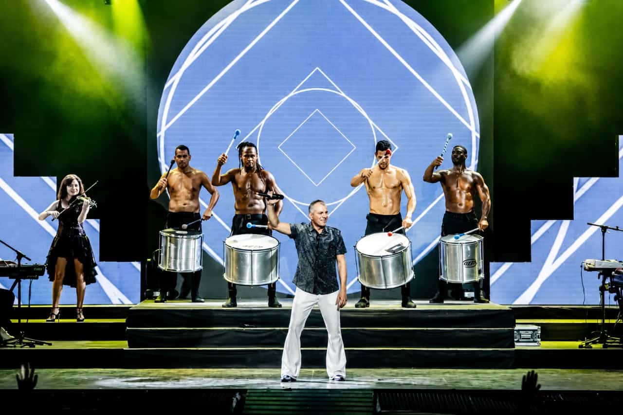 Live musicians and drummers performing on stage during an evening show in Tenerife