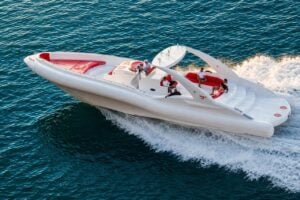 Opera 60 cruising along the Tenerife coast with a small group of guests seated on board