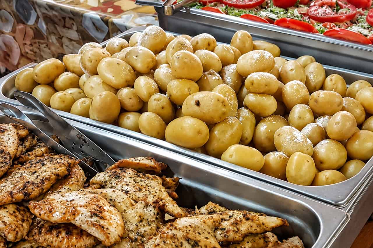 Food buffet with potatoes, grilled chicken and fresh salad on a Gran Canaria boat party
