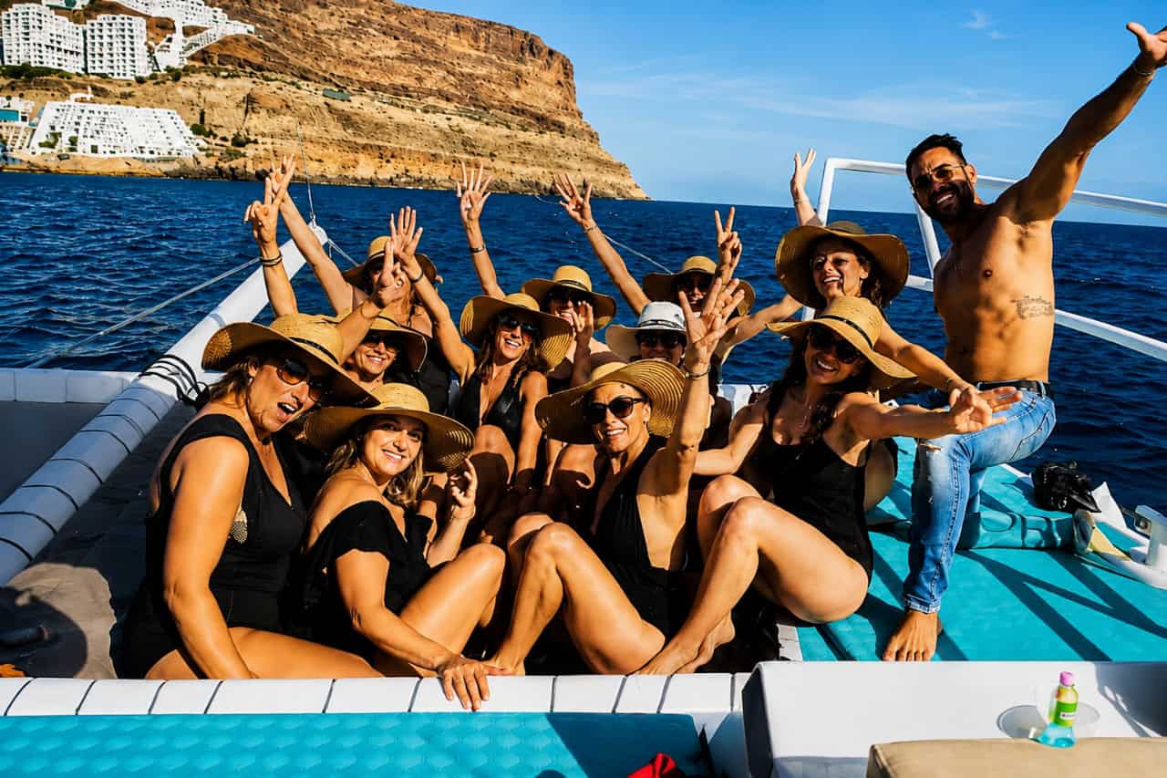 People enjoying the atmosphere aboard a Gran Canaria boat party catamaran
