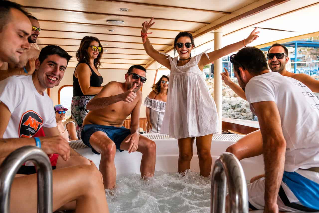 People socialising with drinks on board a Gran Canaria boat party