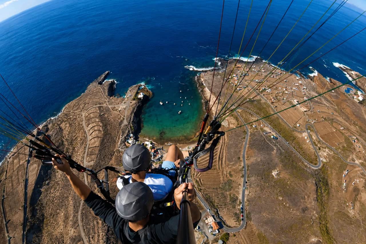Aerial view from a tandem paragliding flight over the volcanic coastline of Tenerife