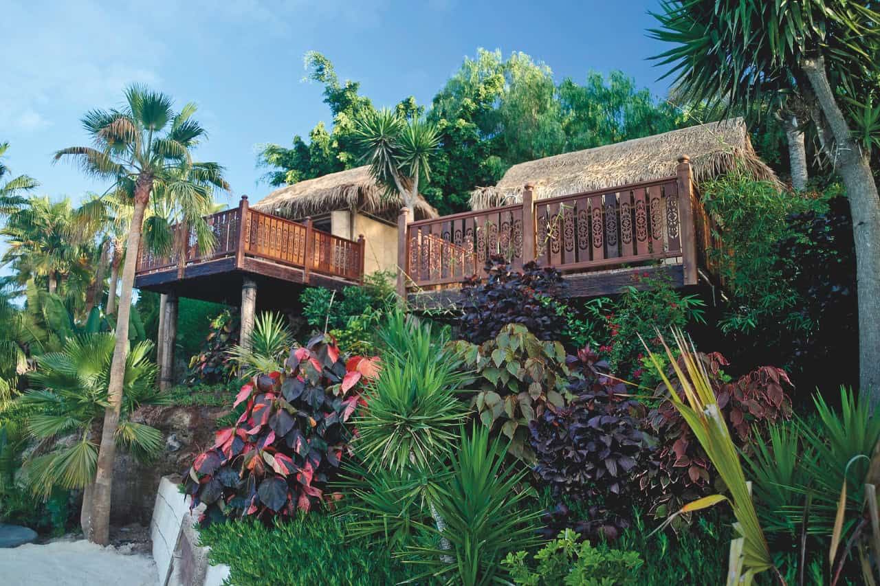 VIP cabana at Siam Park Tenerife surrounded by palm trees and tropical gardens.