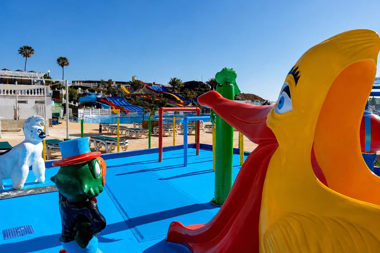 Colourful water slides and a shallow play pool designed for children at a water park in Fuerteventura.