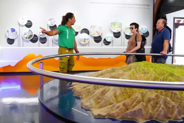 Guide explaining La Gomera island model at Juego de Bolas Visitor Center during small group tour