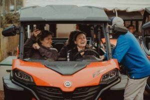 Happy woman on the buggy with the guide explaining
