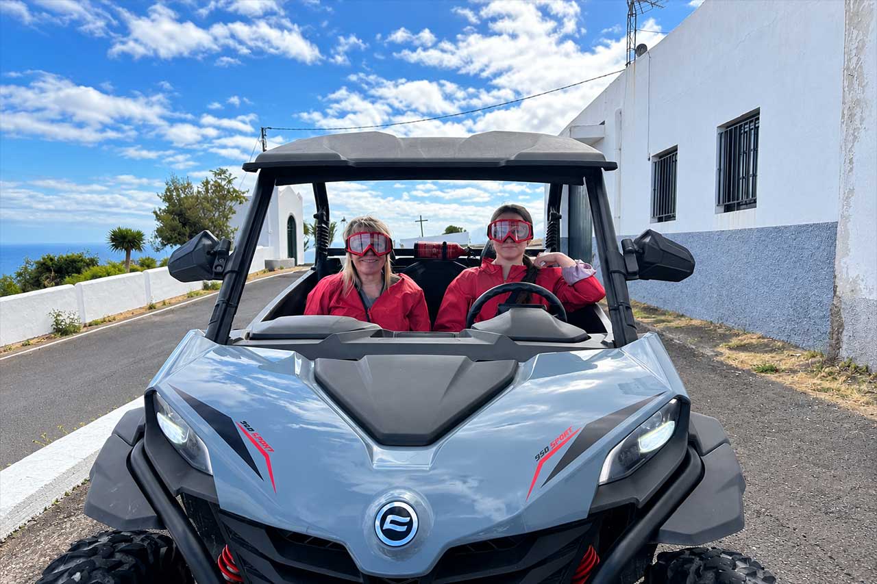 Two guests sit inside their buggy wearing protective goggles and windbreaker jackets before continuing the self-drive adventure through North Tenerife. Protective glasses and windbreakers are included with the tour.