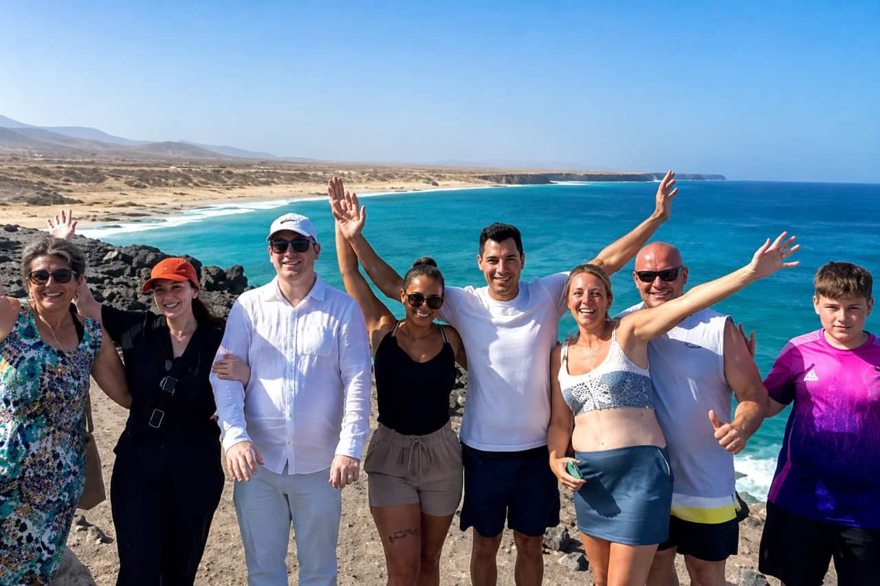 Family posing at a viewpoint over the turquoise coast on a private Fuerteventura tour