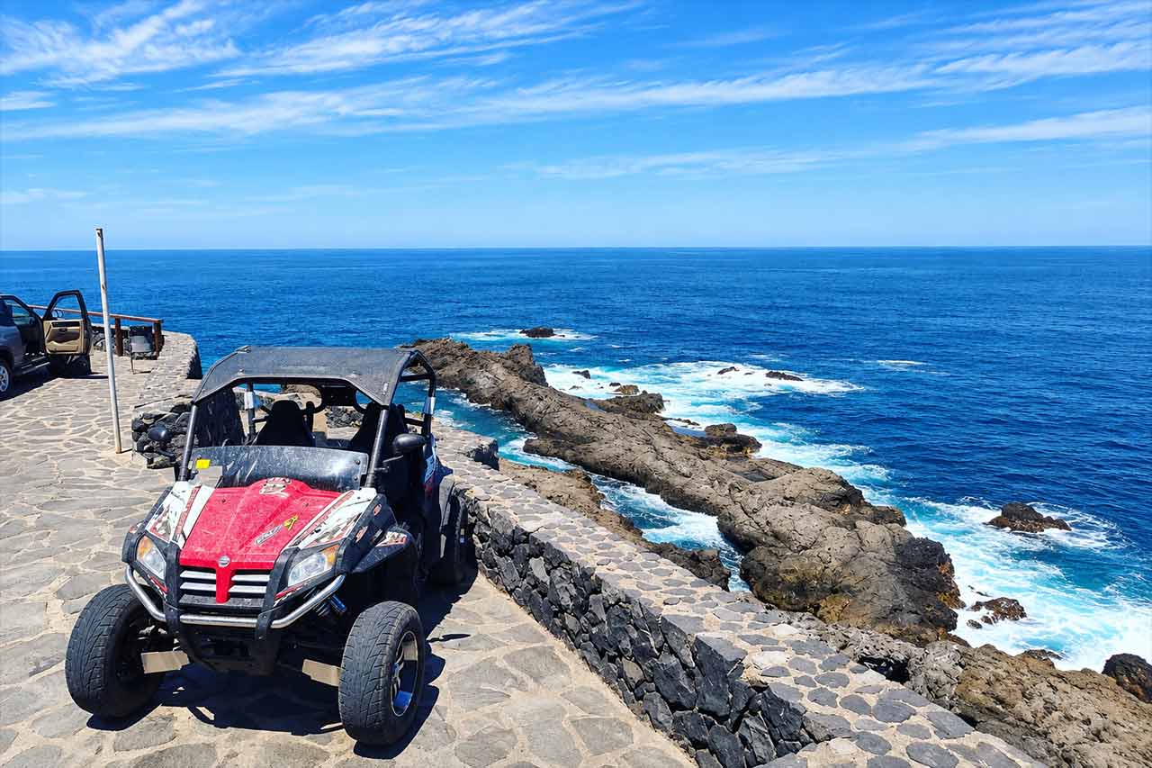 Self-drive buggy parked at a scenic coastal viewpoint in North Tenerife during the Puerto de la Cruz buggy tour, with volcanic rocks and panoramic Atlantic Ocean views.
