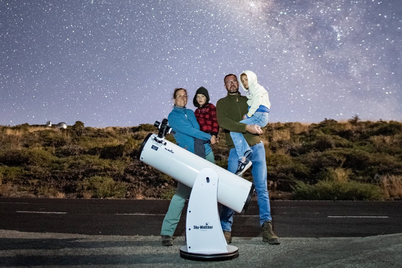 Family with children on La Palma private stargazing experience using powerful telescope at mountain meeting point