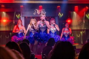 Gran Canaria drag show at MHT Bahía Feliz with live singers and dancers performing on stage during the comedy dinner show