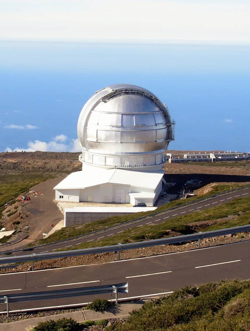 Roque de los Muchachos Astrophysical Observatory dome in La Palma with mountain road and Atlantic Ocean view