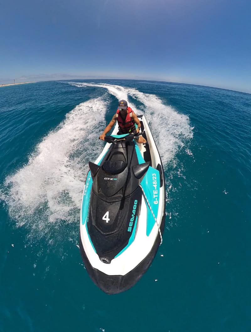 Rider cruising on a Sea-Doo jet ski along the Morro Jable coast on a Fuerteventura jet ski hire