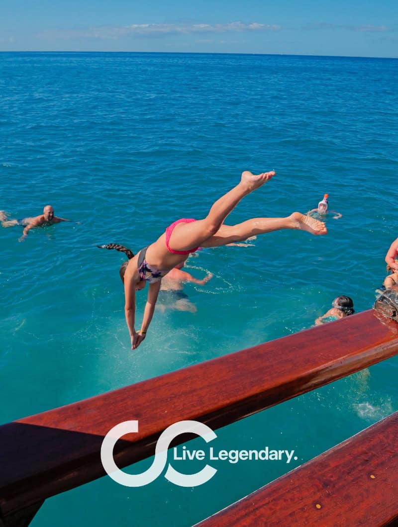 Guest jumping off the Shogun boat into the ocean at the swim stop Tenerife, booked with Club Canary