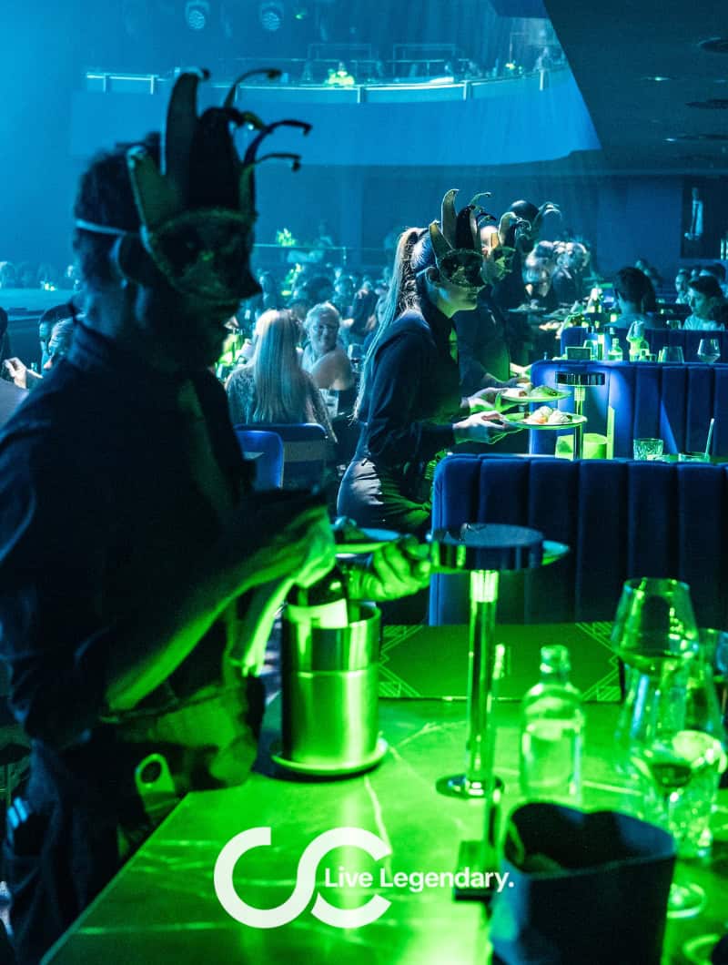 Masked waiters in costume serve guests during the Nomad VIP dinner show in Gran Canaria
