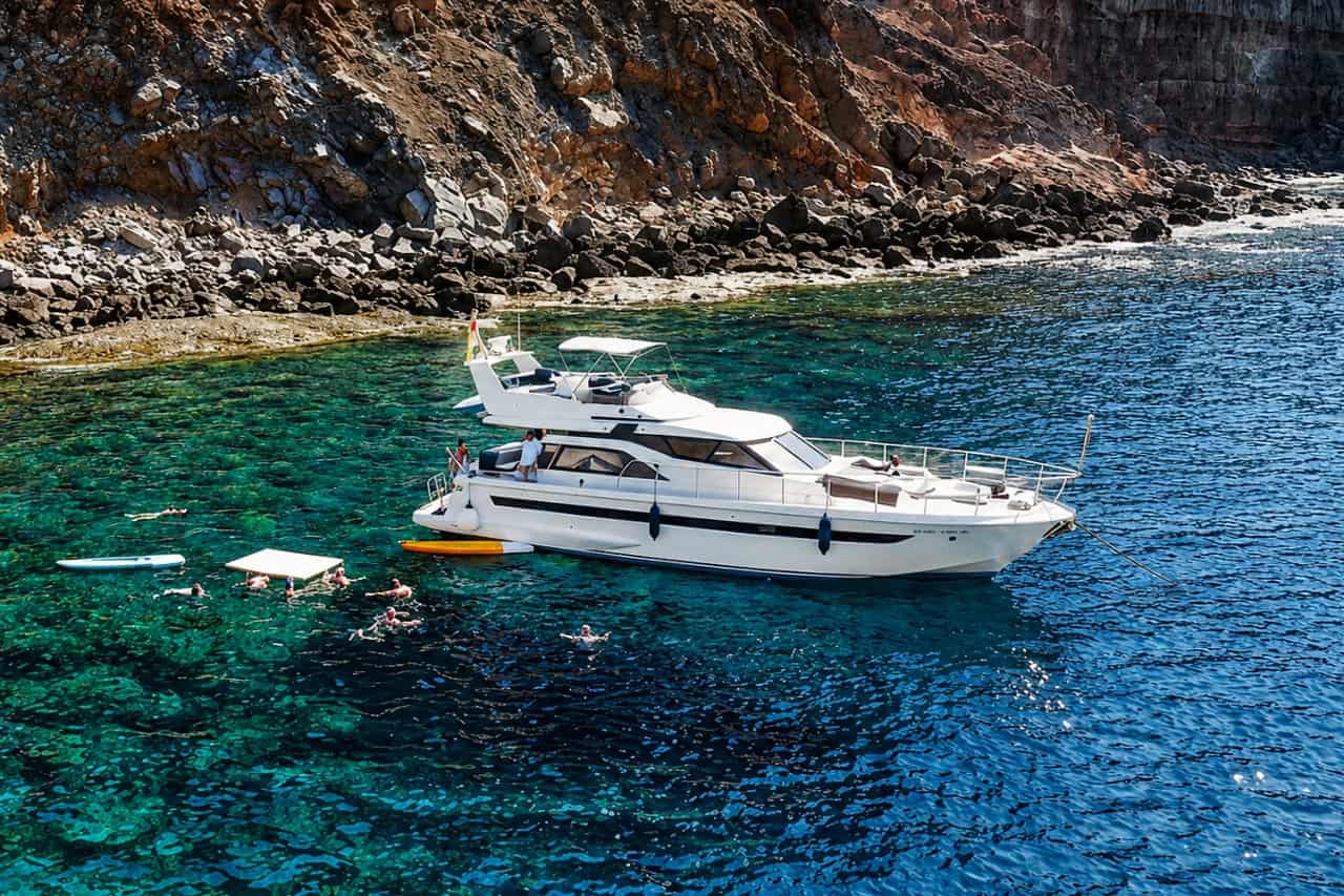 Blue M yacht anchored in clear water during a Gran Canaria boat trip