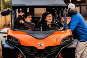 Happy guests preparing for a buggy trip from Puerto de la Cruz in an orange off-road buggy.