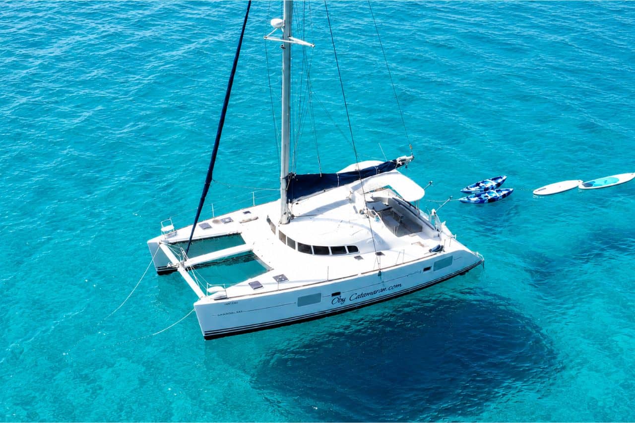 Aerial view of a private catamaran anchored in turquoise water off Corralejo