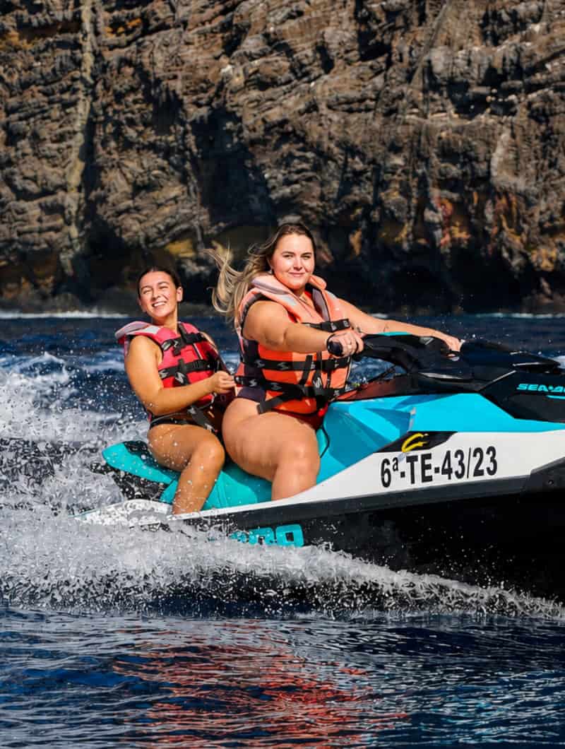 Guided group jet ski tour riding together along the Los Gigantes cliffs in Tenerife.