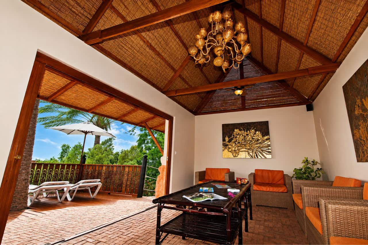 Interior lounge area of the Siam Park VIP Villa with seating, tropical decor and access to the private terrace.