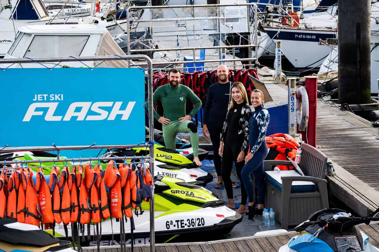 Guests and staff at the Tenerife jet ski safari meeting point with Sea-Doo jet skis, life jackets and wetsuits ready before the briefing.