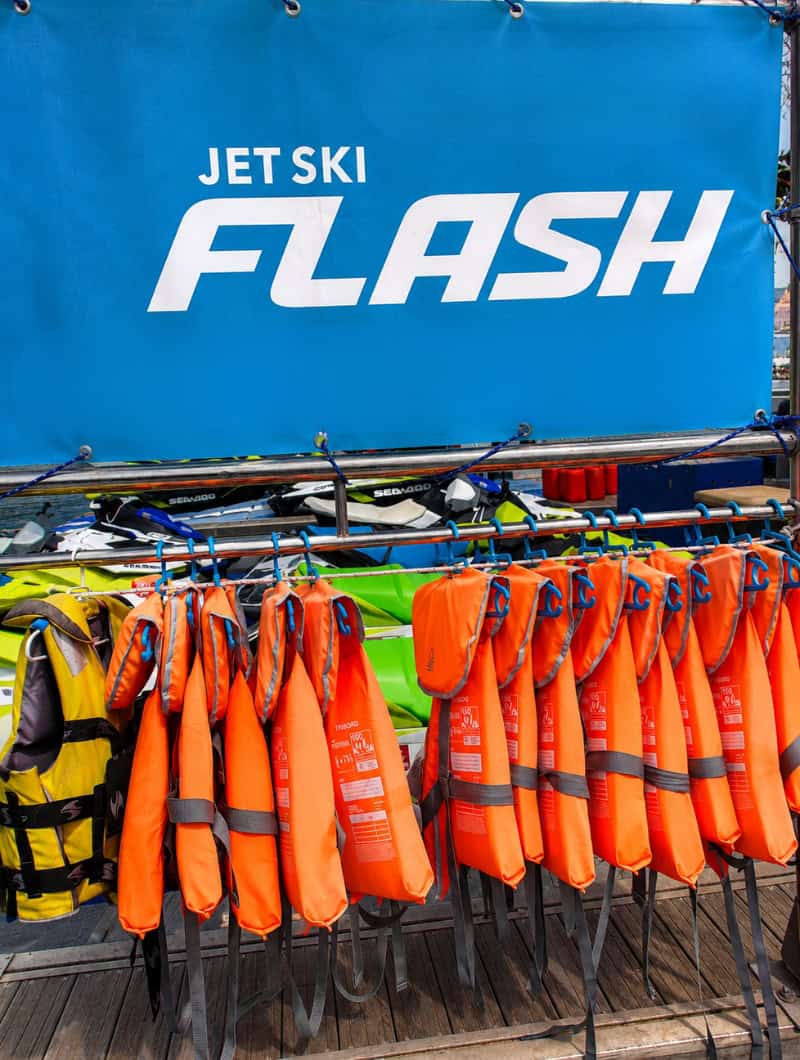 Life jackets prepared for a Tenerife jet ski safari, with Sea-Doo jet skis ready in the background.