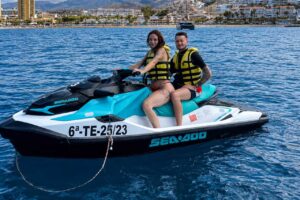 Ein Paar sitzt auf einem Sea-Doo-Jetski während einer Jetski-Tour ab Puerto Colón in Costa Adeje auf Teneriffa.