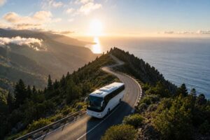 Tour bus driving along a scenic mountain road in La Palma with panoramic ocean views, lush forests and dramatic coastal landscapes during a day trip from Tenerife.