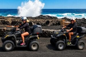 Quad riders near volcanic coastline during a Lanzarote quad tour