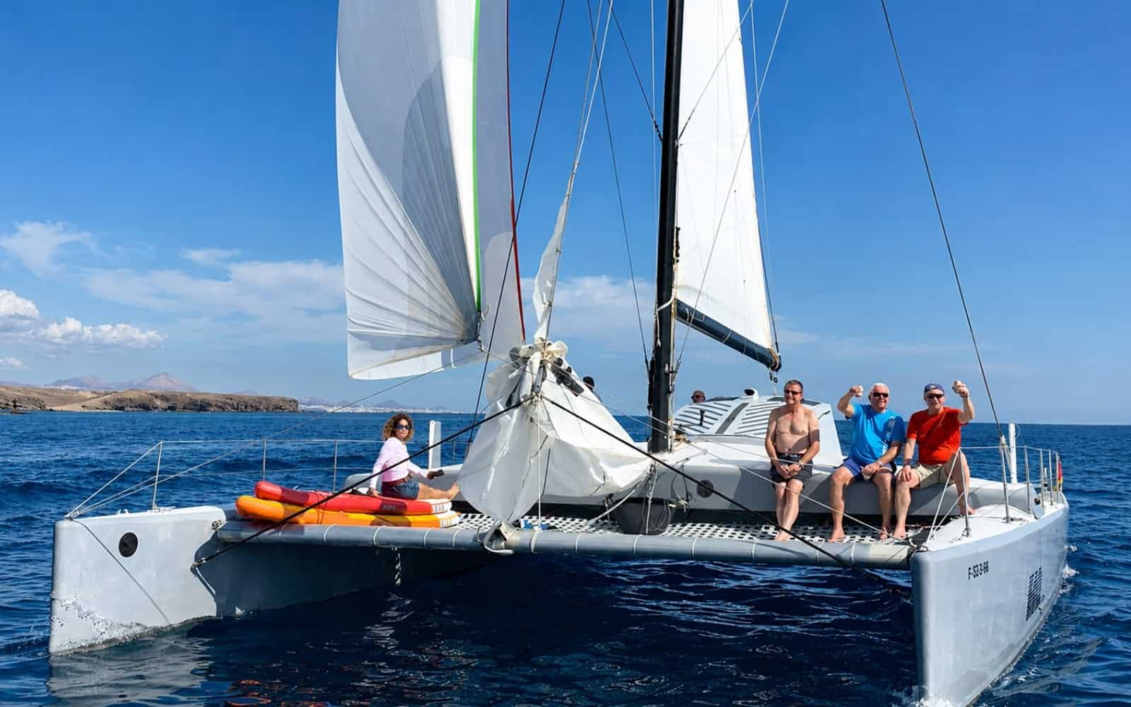 Guests on a sailing catamaran along the Lanzarote coast