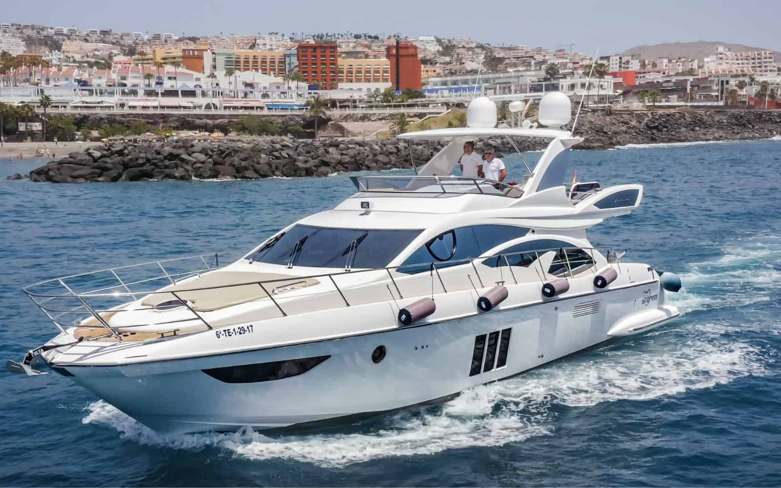 White luxury yacht cruising along the Tenerife coast