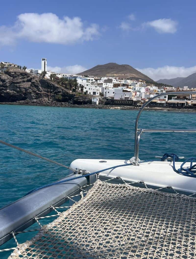 Coastal views from the bow while sailing the private catamaran along the Morro Jable coast, Fuerteventura