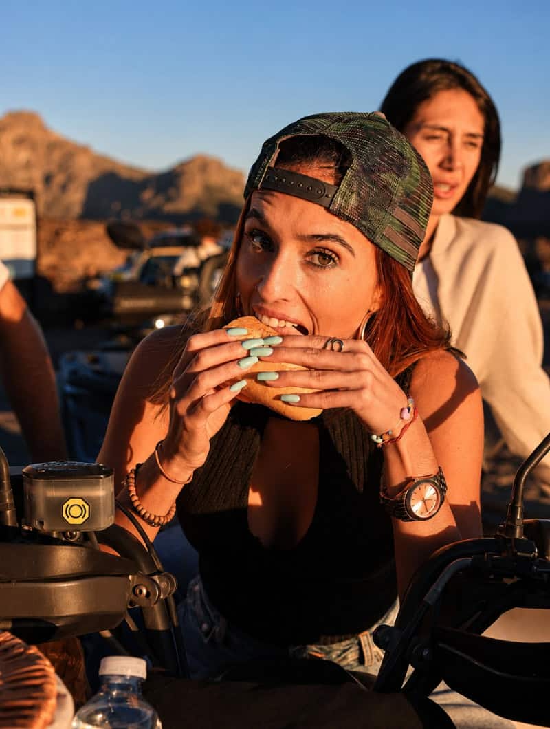 Guest enjoying a small sandwich break during the Monster Quad Tenerife tour near Mount Teide.