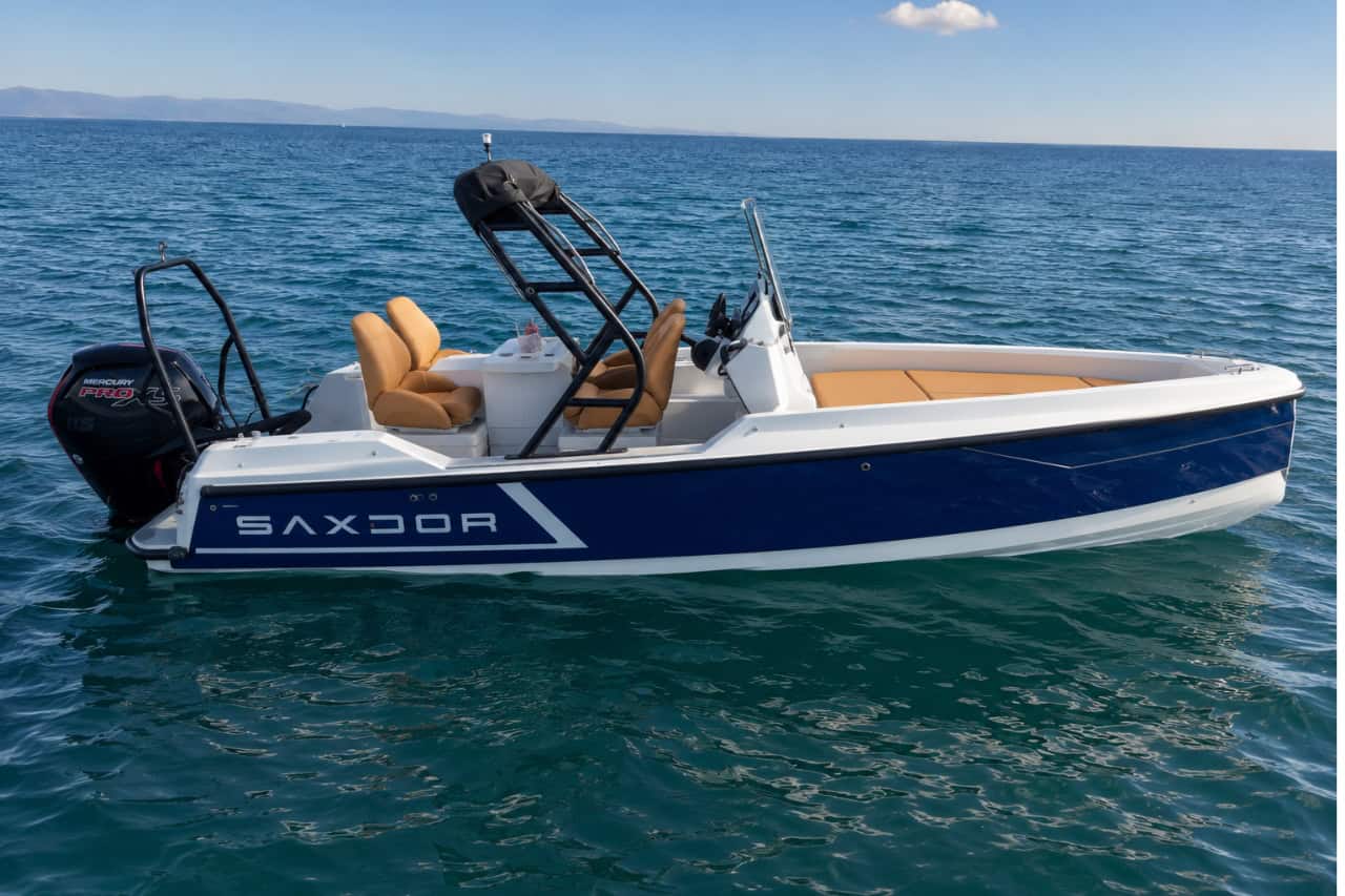 Blue and white Saxdor motorboat floating on the crystal-clear waters off Tenerife, available for private self-drive boat rental and coastal adventures.