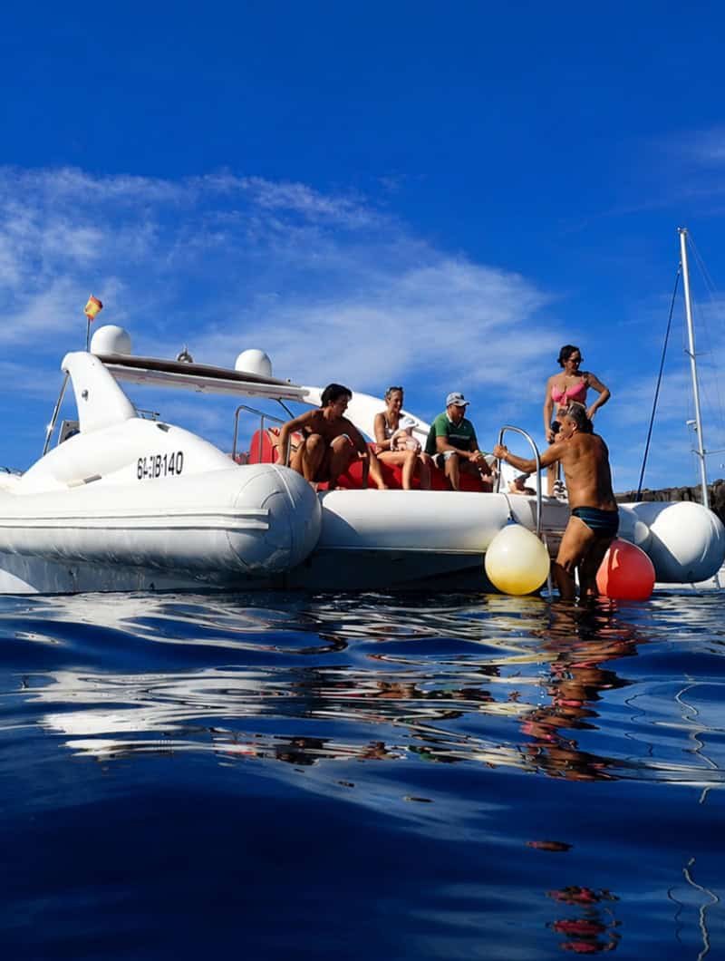 Guests returning to the Opera 60 after swimming during a small-group boat trip in Tenerife