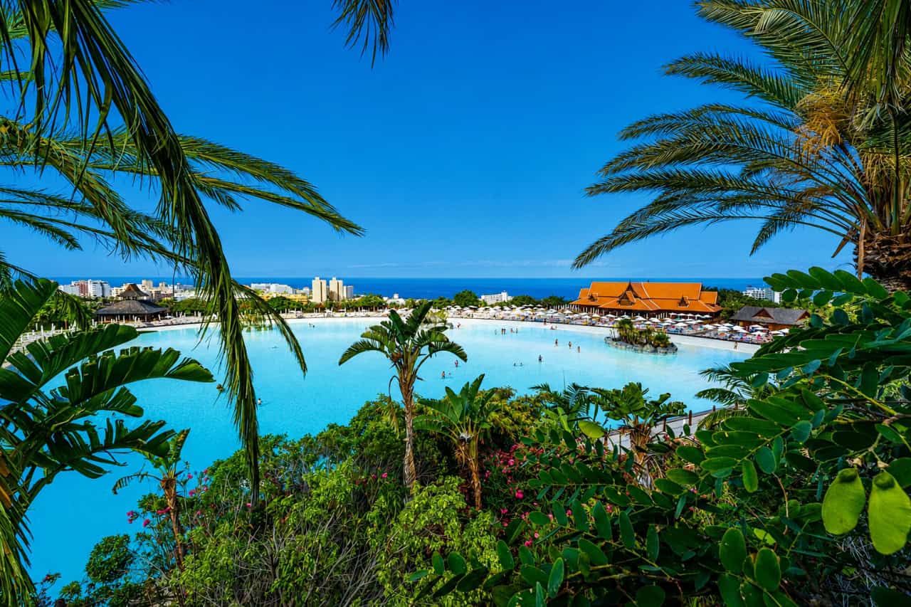 Siam Park beach lagoon in Tenerife with tropical gardens and clear blue water.