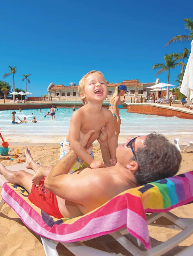 Father and son laughing at Coco Beach in Siam Park
