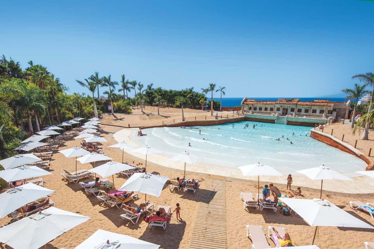 Sun loungers and umbrellas around the calm wave pool at Coco Beach, Siam Park, Tenerife
