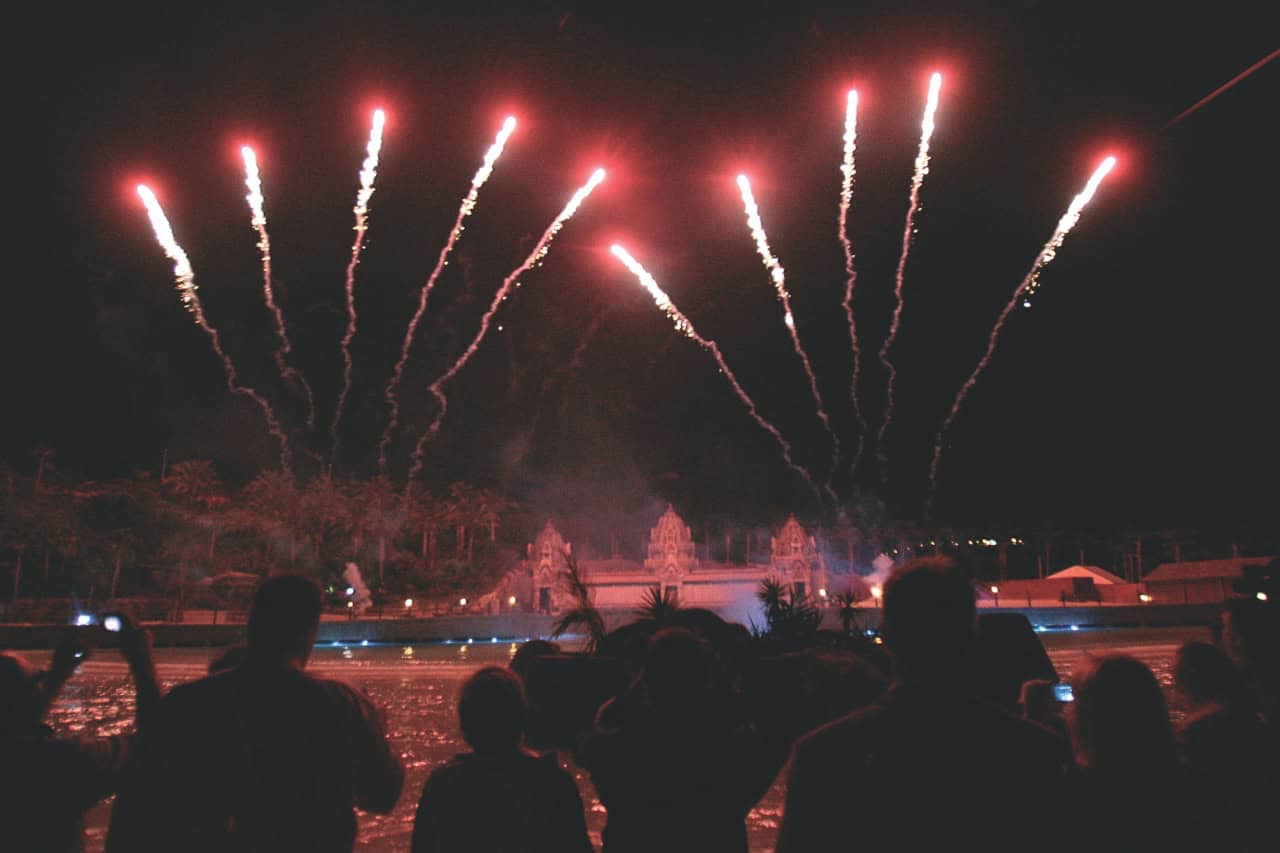 Crowd watching fireworks light up the sky above the Thai temple at Siam Park Night in Tenerife