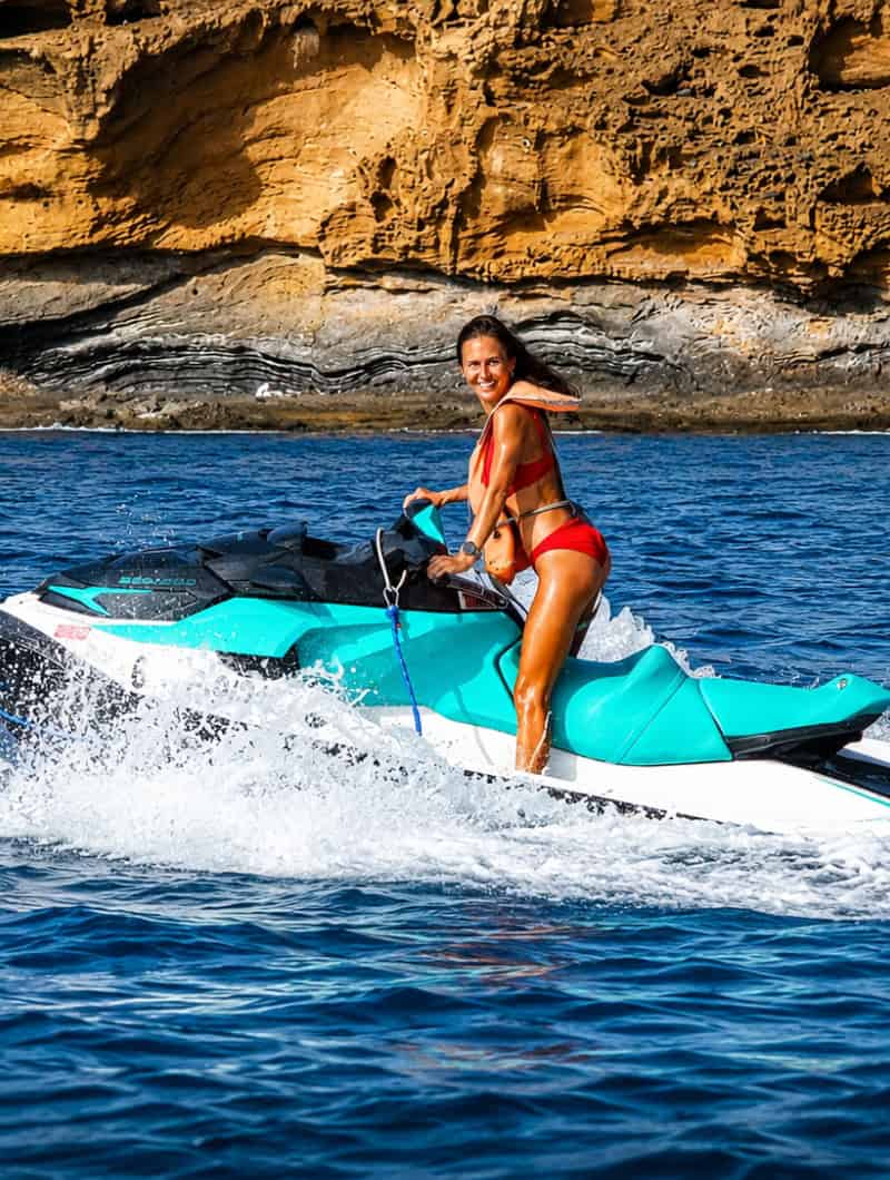 Woman riding alone on a Sea-Doo jet ski in Tenerife, showing the single jet ski option for one driver.