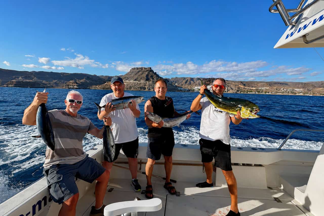 Four anglers showing their Atlantic catches on a small group fishing trip in Gran Canaria