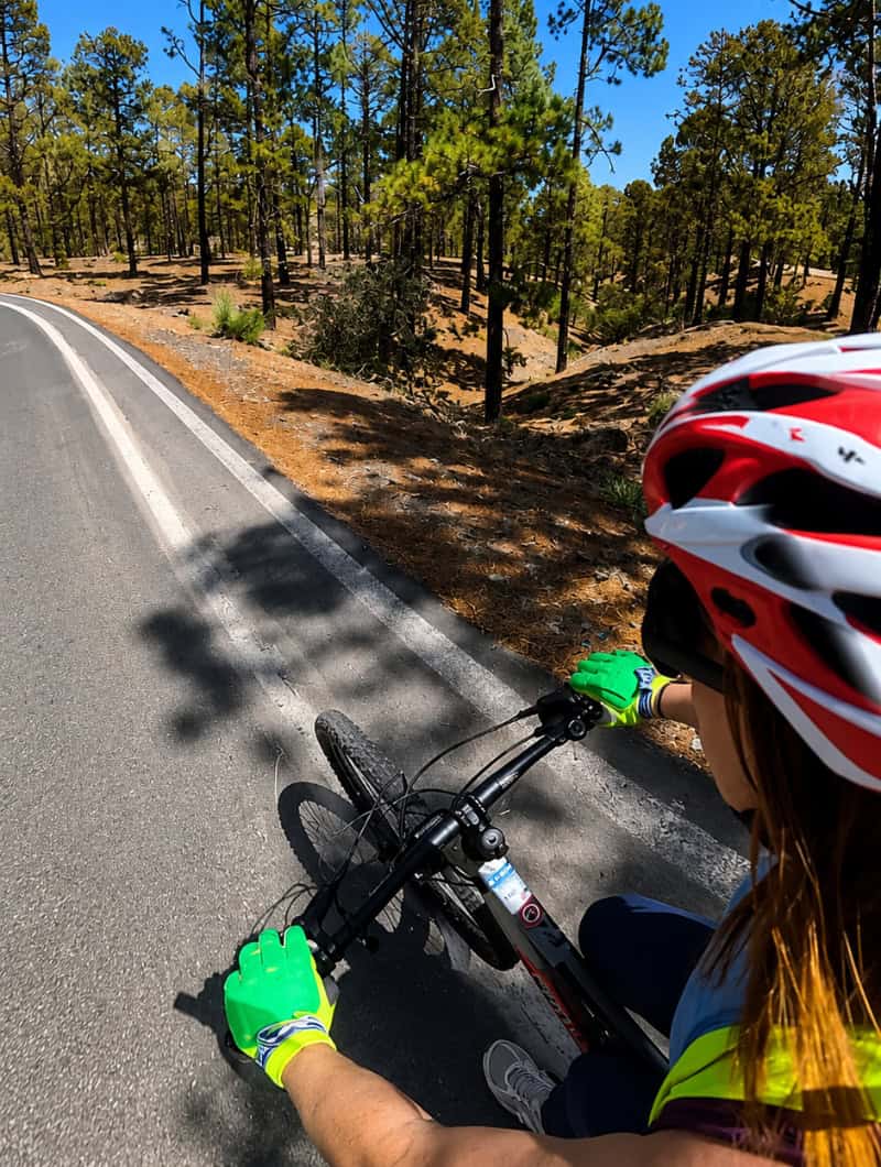 Starting the Downhill Bike Tour Through Tenerife’s Pine Forest Cyclist beginning the downhill bike tour on a mountain road through Tenerife’s pine forest at high altitude near Mount Teide.
