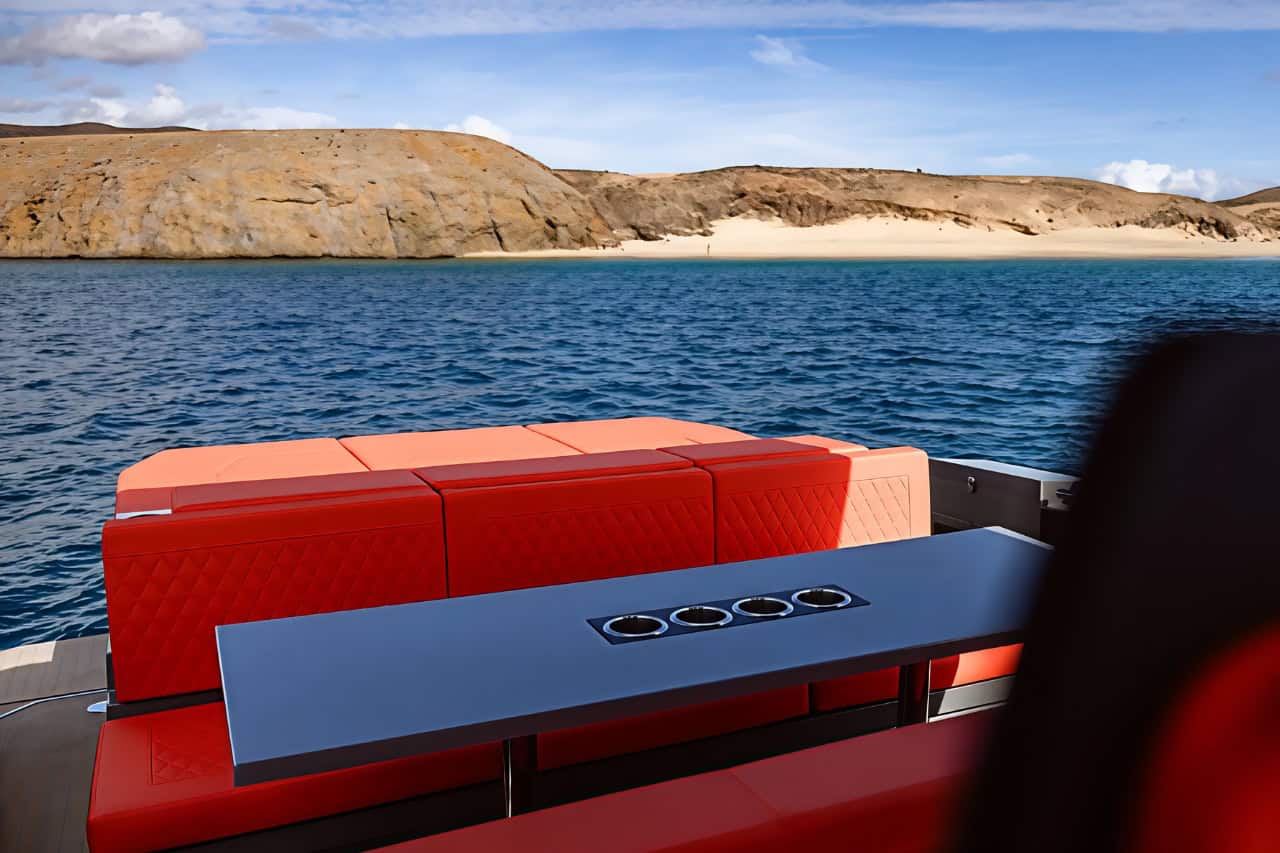 Rear seating area of the BlackDune boat with a view over the sea and beach in Gran Canaria.